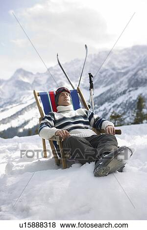 Skier resting in deckchair in mountains View Large Photo Image Stock Photo - Skier resting in deckchair in mountains. Fotosearch