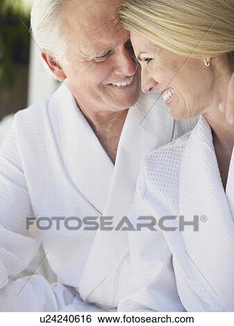 Stock Photograph - Smiling couple in bathrobes. Fotosearch