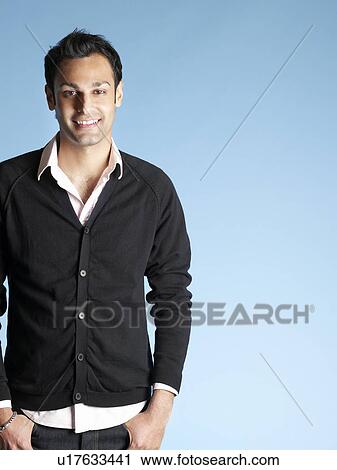 Stock Image - Smiling mid adult man on blue background. Fotosearch