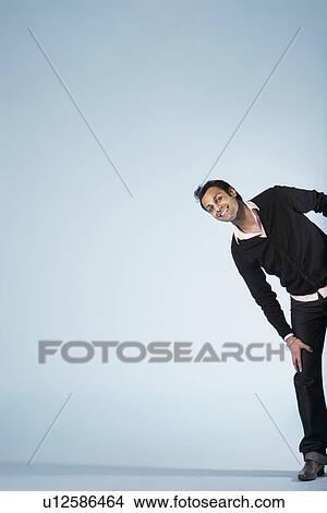 Smiling mid-adult man on blue background (cropped) View Large Photo Image Picture - Smiling mid-adult man on blue background (cropped). Fotosearch