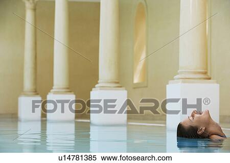 Smiling woman leaning backwards in swimming pool portrait View Large Photo Image Stock Photography - Smiling woman leaning backwards in swimming pool portrait. Fotosearch