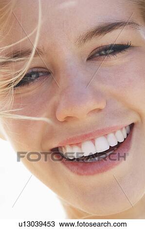 Stock Image - Smiling young woman portrait close-up. Fotosearch