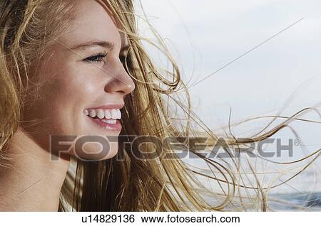 Smiling young woman profile close-up View Large Photo Image Stock Photograph - Smiling young woman profile close-up. Fotosearch