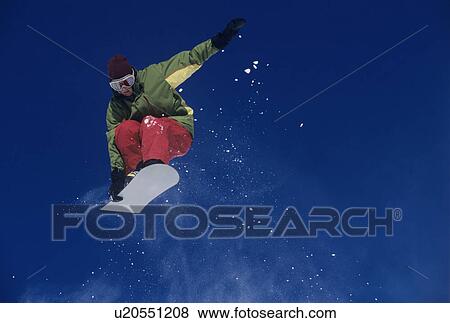 Stock Photo - Snowboarder jumping holding snowboard. Fotosearch