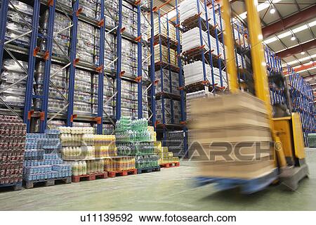 Stock Image - Speeding Forklift in Warehouse. Fotosearch