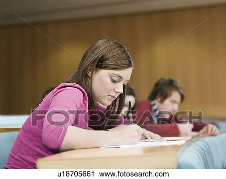 Stock Image - Student in lecture room. Fotosearch