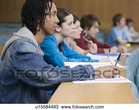 Stock Image - Students in lecture room. Fotosearch