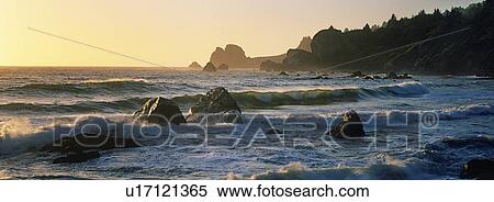 Stock Photography - Surf at sunset. Fotosearch