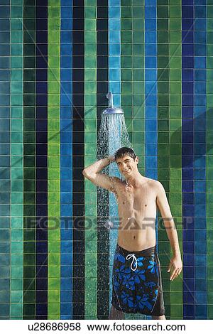 Teenage boy (16-17) standing under outdoor shower portrait View Large Photo Image Stock Photo - Teenage boy (16-17) standing under outdoor shower portrait. Fotosearch