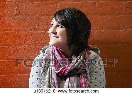 Teenage girl (16-17) looking away and grinning View Large Photo Image Stock Photo - Teenage girl (16-17) looking away and grinning. Fotosearch