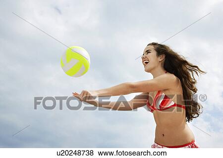 Teenage girl (16-17) playing beach volleyball low angle view View Large Photo Image Stock Photo - Teenage girl (16-17) playing beach volleyball low angle view. Fotosearch