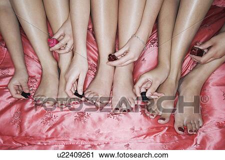 Teenage girls painting toenails on pink sheets high angle view close-up View Large Photo Image Stock Image - Teenage girls painting toenails on pink sheets high angle view close-up. Fotosearch