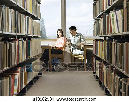 Teenagers doing homework in library View Large Photo Image Stock Image - Teenagers doing homework in library. Fotosearch