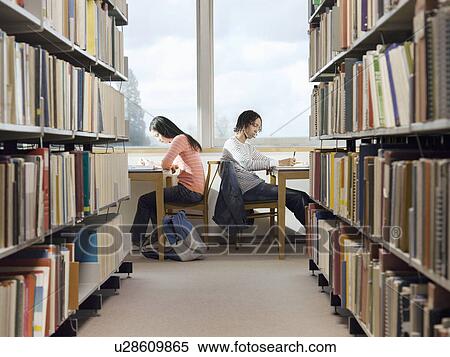 Teenagers doing homework in library View Large Photo Image Stock Photography - Teenagers doing homework in library. Fotosearch