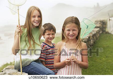 Three children (5-6 7-910-12) holding fishing nets portrait View Large Photo Image Stock Image - Three children (5-6 7-910-12) holding fishing nets portrait. Fotosearch