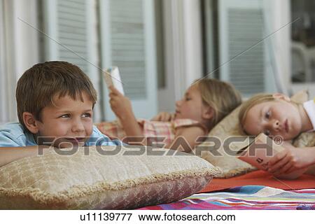 Stock Photo - Three Children Relaxing. Fotosearch