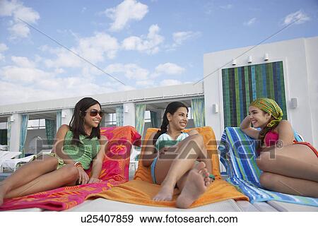 Three teenage girls (16-17) lying on sunloungers View Large Photo Image Stock Photo - Three teenage girls (16-17) lying on sunloungers. Fotosearch