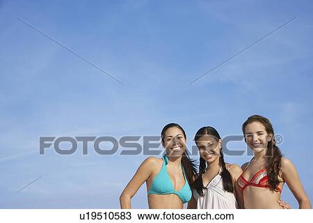Three teenage girls (16-17) wearing bikinis pictured against sky portrait View Large Photo Image Stock Image - Three teenage girls (16-17) wearing bikinis pictured against sky portrait. Fotosearch