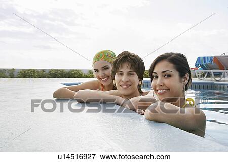 Three teenagers (16-17) in swimming pool portrait View Large Photo Image Stock Photo - Three teenagers (16-17) in swimming pool portrait. Fotosearch