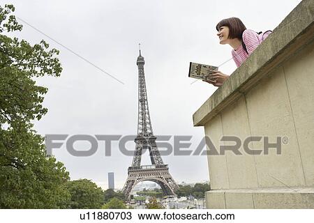 Stock Image - Tourist Sightseeing and Eiffel Tower. Fotosearch