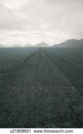 Track through field leading to mountains View Large Photo Image Stock Image - Track through field leading to mountains. Fotosearch