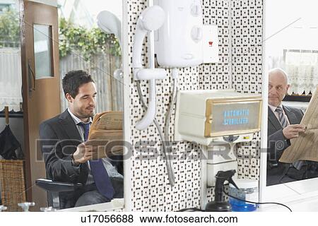 Two business men waiting for haircut in barber shop View Large Photo Image Stock Photo - Two business men waiting for haircut in barber shop. Fotosearch