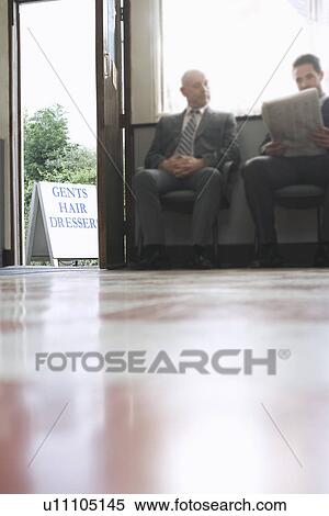 Stock Photography - Two business men waiting in barber shop. Fotosearch