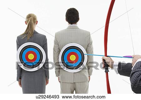 Two business people with targets on backs while man aims bow and arrow (close-up of hands) against white background View Large Photo Image Stock Image - Two business people with targets on backs while man aims bow and arrow (close-up of hands) against white background. Fotosearch