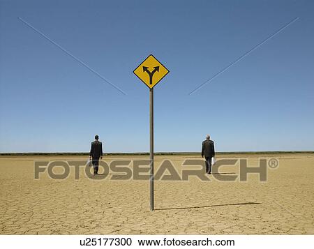 Two businessmen with briefcases in desert back view road sign in foreground View Large Photo Image Stock Image - Two businessmen with briefcases in desert back view road sign in foreground. Fotosearch