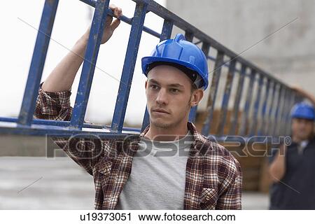 Two construction workers carrying ladder View Large Photo Image Stock Image - Two construction workers carrying ladder. Fotosearch