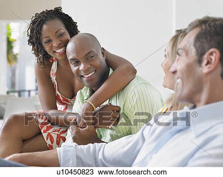 Stock Image - Two couples chatting. Fotosearch