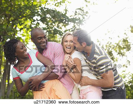 Two couples laughing in garden View Large Photo Image Stock Image - Two couples laughing in garden. Fotosearch
