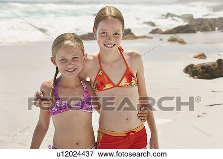 Two girls (7-9 10-12) posing on beach portrait View Large Photo Image Stock Photo - Two girls (7-9 10-12) posing on beach portrait. Fotosearch