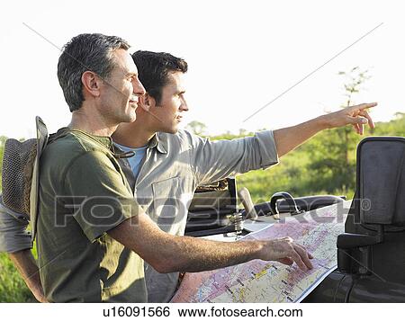 Two men with map one pointing View Large Photo Image Stock Photograph - Two men with map one pointing. Fotosearch