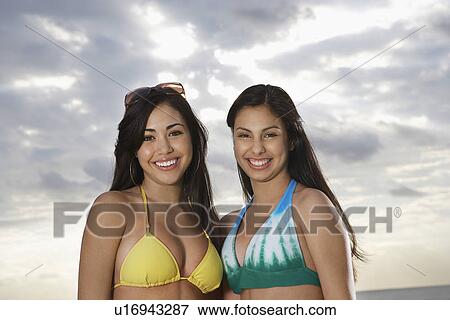 Stock Photo - Two teenage girls (16-17) in bikini portrait. Fotosearch