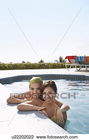 Two teenage girls (16-17) in swimming pool portrait View Large Photo Image Stock Image - Two teenage girls (16-17) in swimming pool portrait. Fotosearch