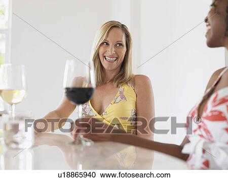 Stock Image - Two women drinking wine. Fotosearch