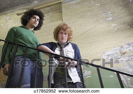 Two young men in old dilapidated building View Large Photo Image Stock Image - Two young men in old dilapidated building. Fotosearch