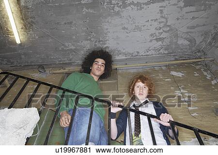 Two young men in old dilapidated building View Large Photo Image Stock Image - Two young men in old dilapidated building. Fotosearch