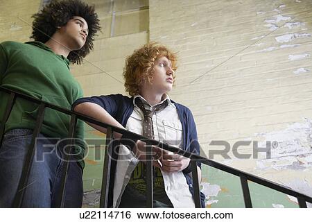 Two young men in old dilapidated building View Large Photo Image Stock Photograph - Two young men in old dilapidated building. Fotosearch