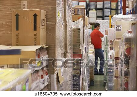 Warehouse worker standing in Warehouse Full of cellophane-wrapped Goods View Large Photo Image Stock Photography - Warehouse worker standing in Warehouse Full of cellophane-wrapped Goods. Fotosearch