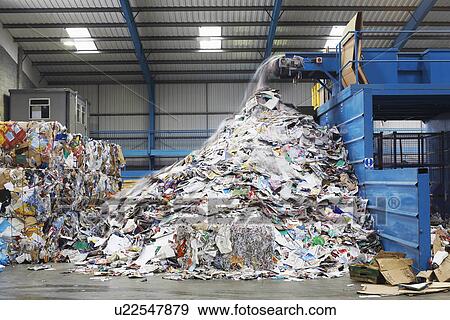 Waste coming out of machine in recycling factory View Large Photo Image Stock Photo - Waste coming out of machine in recycling factory. Fotosearch