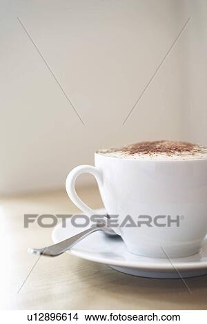 White cup of cappuccino on wooden table close-up View Large Photo Image Picture - White cup of cappuccino on wooden table close-up. Fotosearch