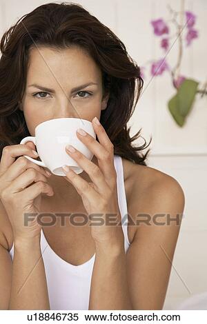 Woman drinking cup of tea half length View Large Photo Image Stock Photography - Woman drinking cup of tea half length. Fotosearch