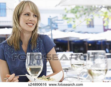 Woman eating meal at outdoor cafe View Large Photo Image Stock Photograph - Woman eating meal at outdoor cafe. Fotosearch