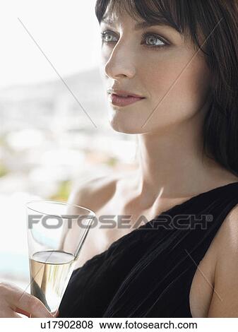 Woman holding champagne outdoors View Large Photo Image Stock Photo - Woman holding champagne outdoors. Fotosearch