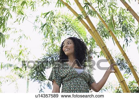Woman in bamboo forest low angle view View Large Photo Image Stock Photo - Woman in bamboo forest low angle view. Fotosearch