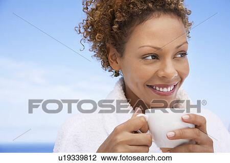 Woman in bathrobe holding up of tea head and shoulders View Large Photo Image Stock Image - Woman in bathrobe holding up of tea head and shoulders. Fotosearch