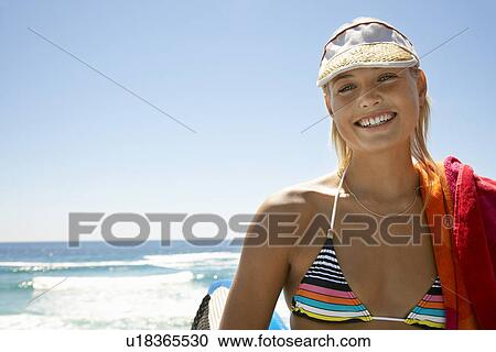 Woman in sun visor at beach head and shoulders View Large Photo Image Stock Image - Woman in sun visor at beach head and shoulders. Fotosearch