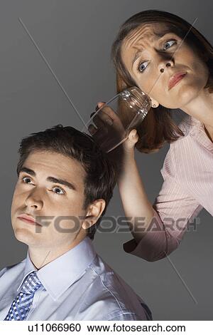 Woman listening through glass to man's head View Large Photo Image Stock Image - Woman listening through glass to man's head. Fotosearch
